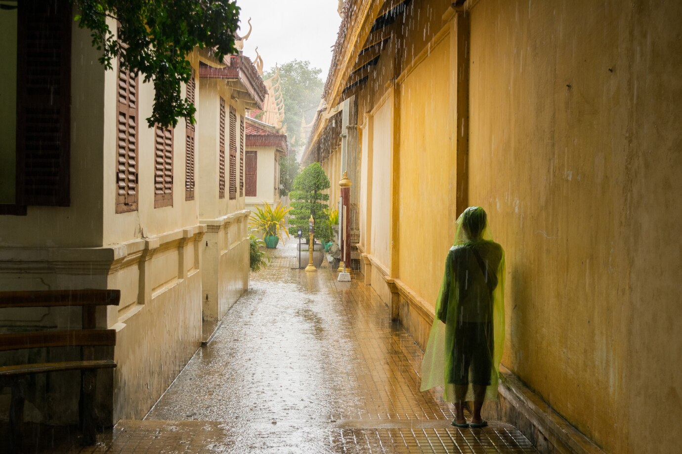 asian-teen-waiting-monsoon-rain-stop_181624-800
