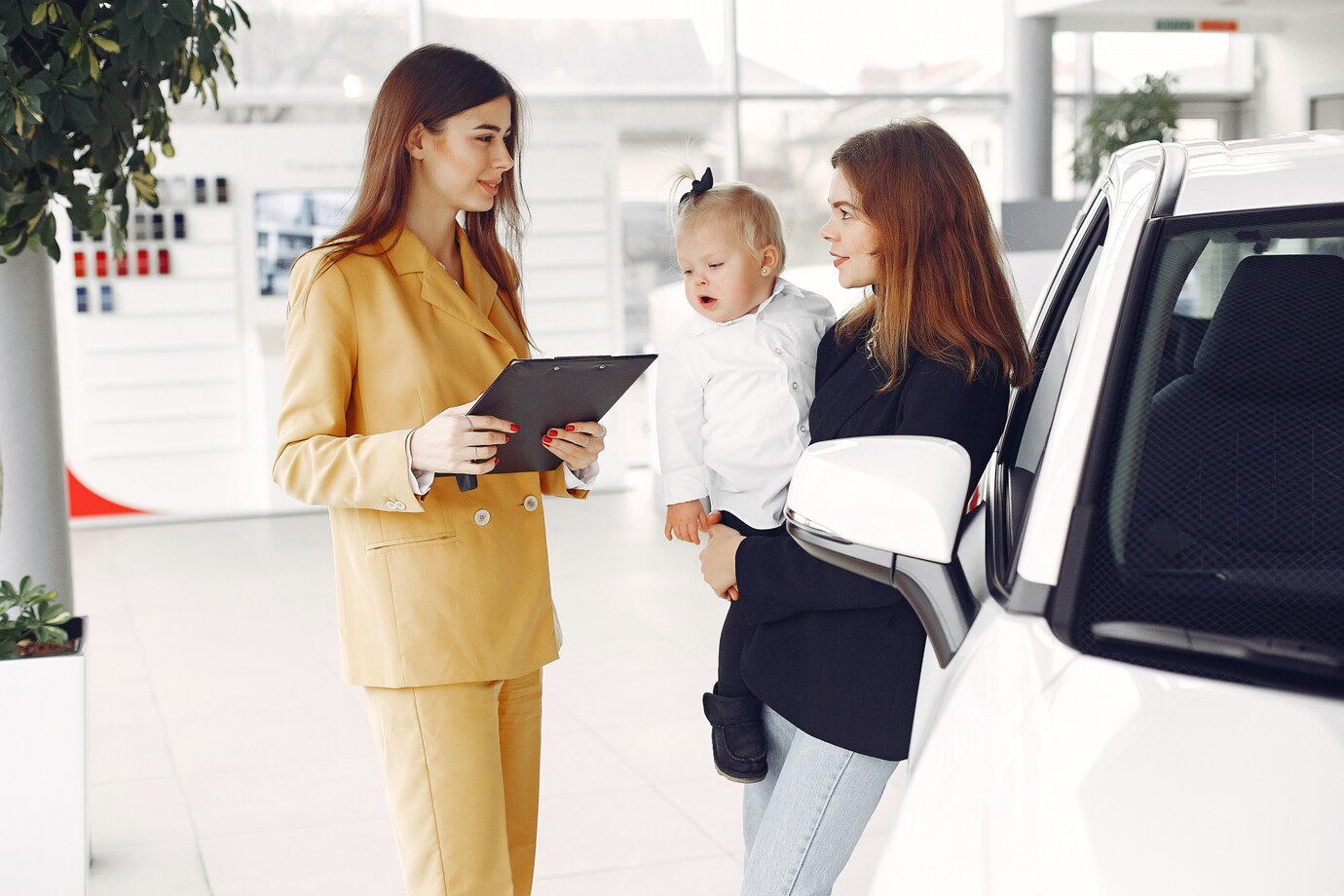 elegant-woman-with-little-daughter-car-salon_1157-33185